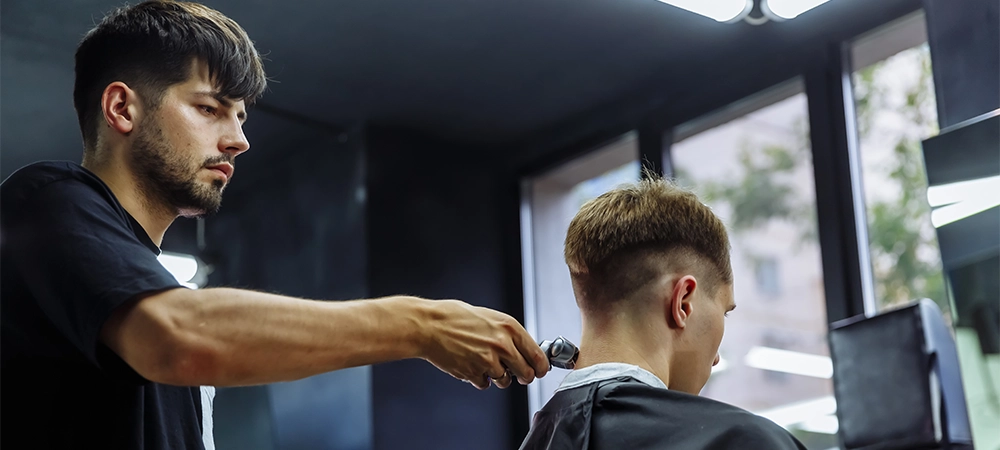 barber cutting taper fade hairstyle