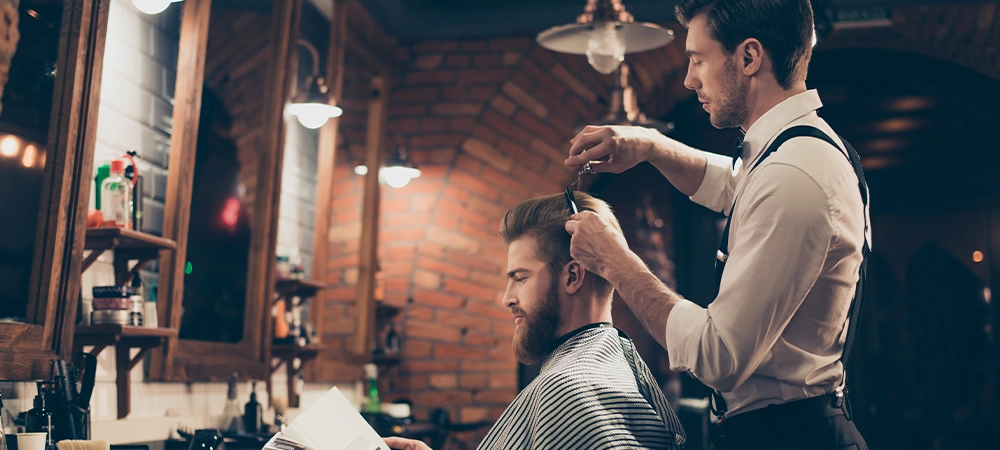 man hair cutting in barber salon